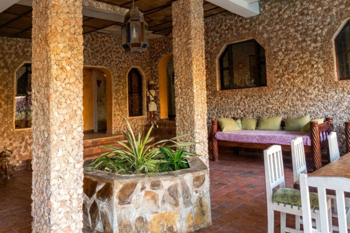 Covered stone terrace with seating at a holiday rental — after enhancement